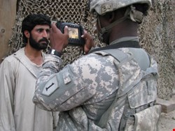 A US Army soldier capturing an iris image with the Handheld Interagency Identity Detection Equipment (HIIDE)