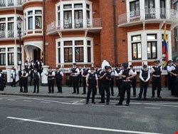 Police watch Julian Assange protest outside the Ecuadorian embassy in London (Photo credit: Chris Harvey/Shutterstock.com) 