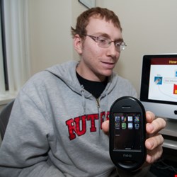 Computer science graduate student Jeffrey Bickford with smart phone used to test malicious software (Photo: Carl Blesch, Rutgers University)