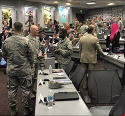 Here, Katie is taking part in a roundtable on a military base, her pink hair amongst a sea of camouflage. Photo credit: Wade Barker