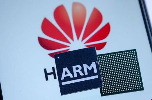 Conceptual photo of Huawei logo on a screen and ARM microchips on top. Credit: Ascannio/Shutterstock